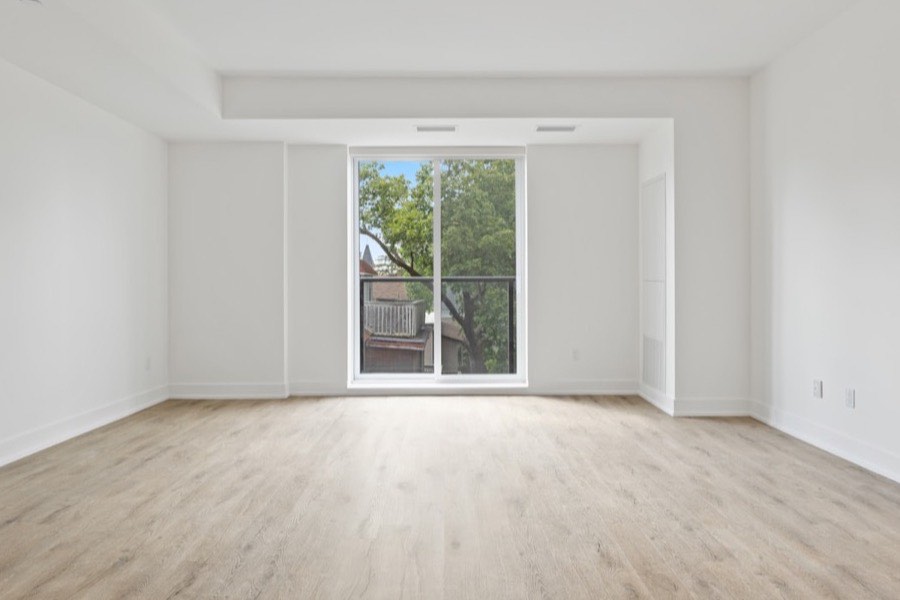 An empty room with clean floors and daylight