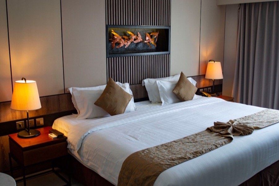 A freshly made bed with crisp white linen